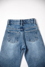 Back view of a pair of blue jeans on a white background