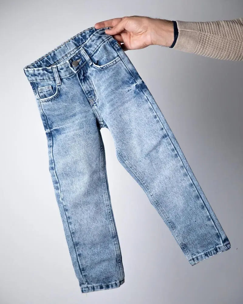 Light blue jeans being held up against a gray background