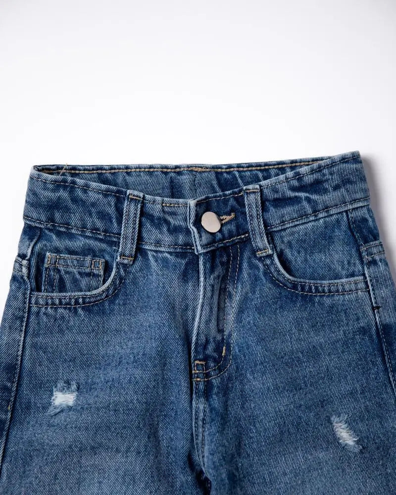 Blue denim jeans with a white background
