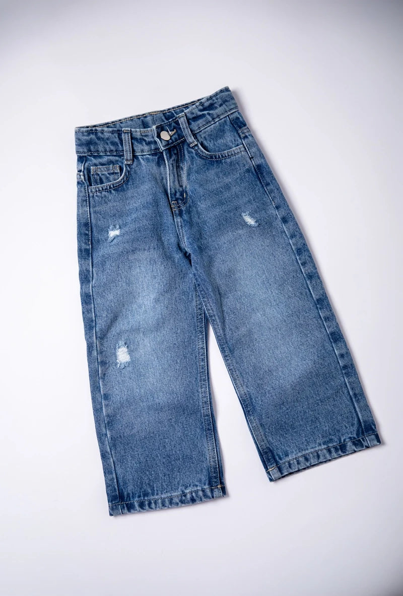 Pair of blue jeans with slight distressing on a white background