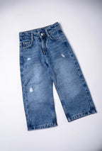 Pair of blue jeans with slight distressing on a white background