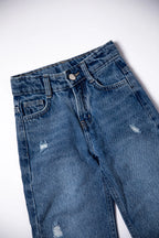 Blue jeans with slight distressing on a white background