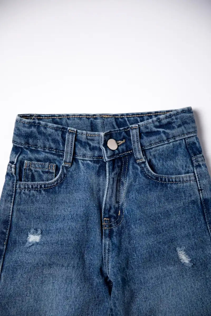 Blue denim jeans with slight distressing on a white background